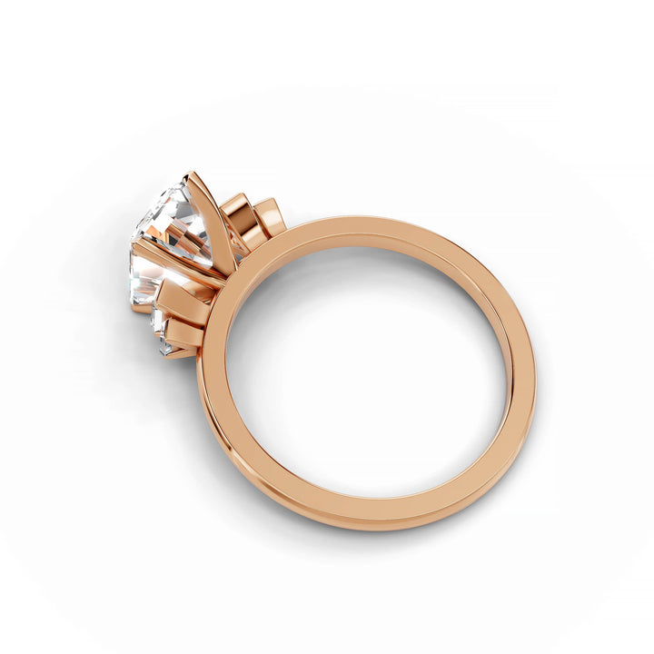 Emerald cut diamond five stone engagement ring in rose gold.