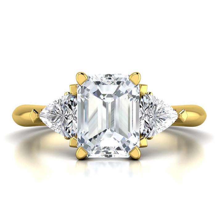 Emerald cut three stone engagement ring