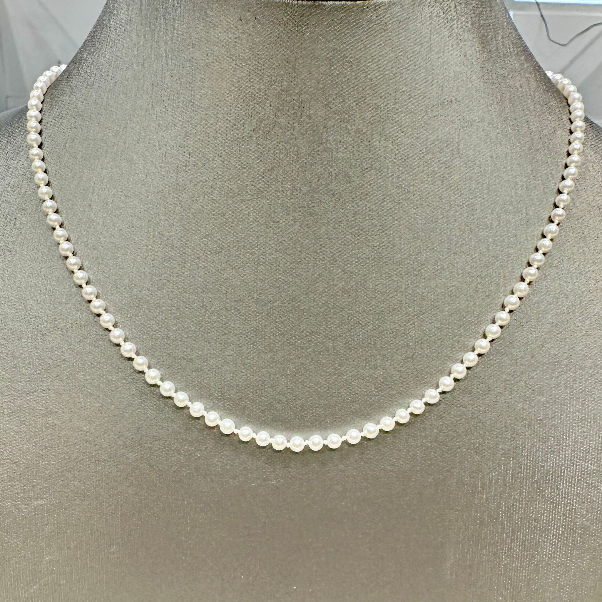 Delicate freshwater pearl necklace with 3.1mm round white pearls, 21 inches long, featuring a 14k yellow gold fish clasp.