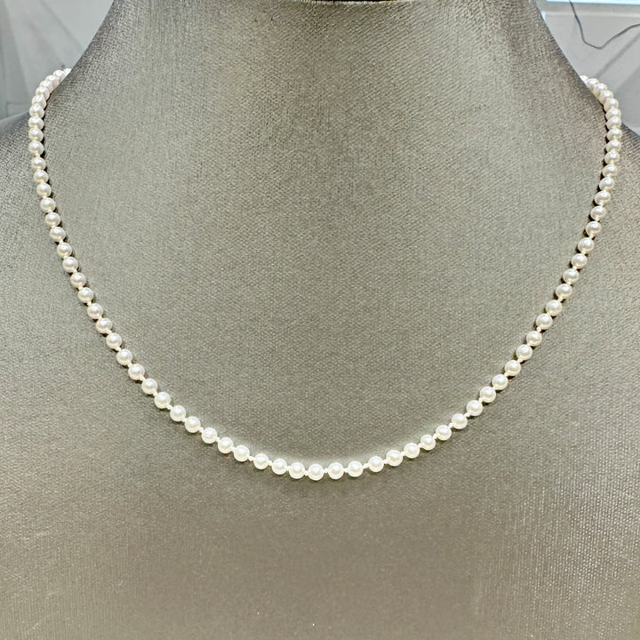 Delicate freshwater pearl necklace with 3.1mm round white pearls, 21 inches long, featuring a 14k yellow gold fish clasp.