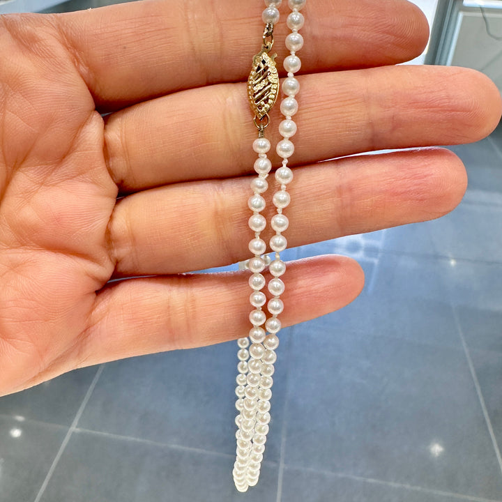 Delicate freshwater pearl necklace with 3.1mm round white pearls, 21 inches long, featuring a 14k yellow gold fish clasp.