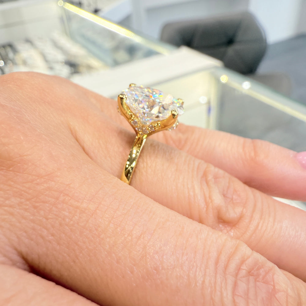 4 Ct oval moissanite engagement ring with hidden halo in 14K yellow gold.