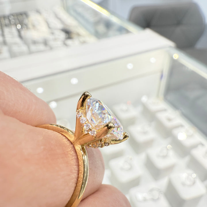 4 Ct oval moissanite engagement ring with hidden halo in 14K yellow gold.