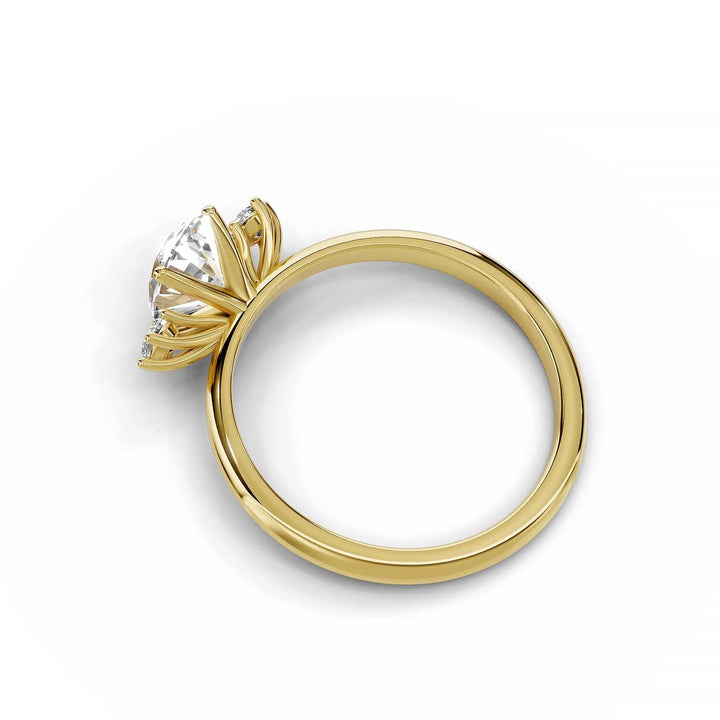 Oval diamond three-stone engagement ring in yellow gold.