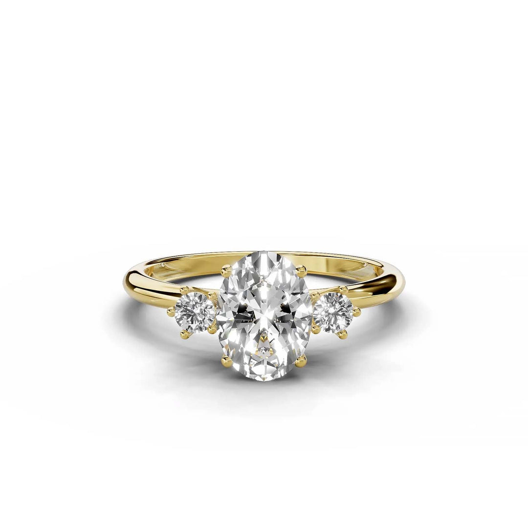 Oval diamond three-stone engagement ring in yellow gold.