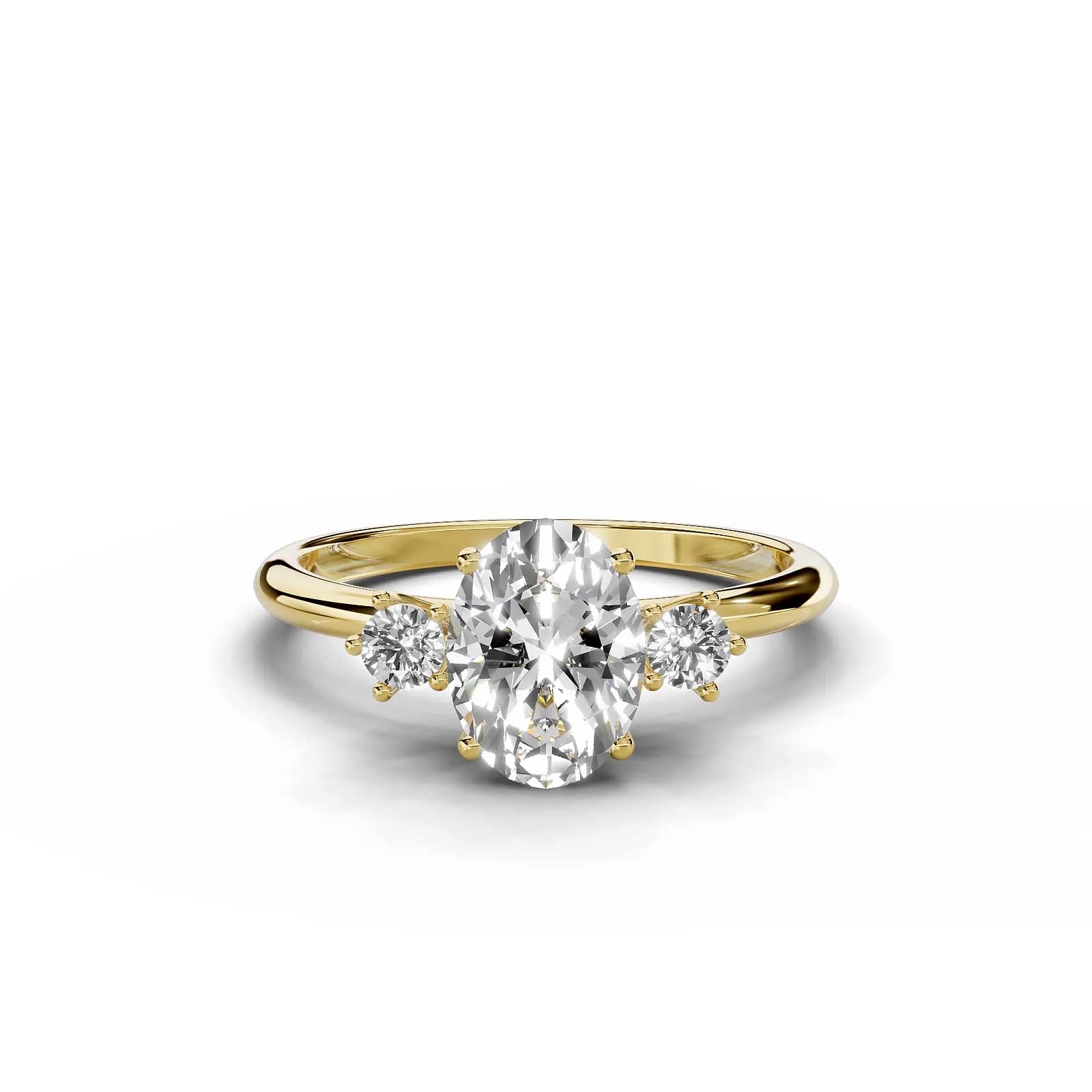 Oval diamond three-stone engagement ring in yellow gold.