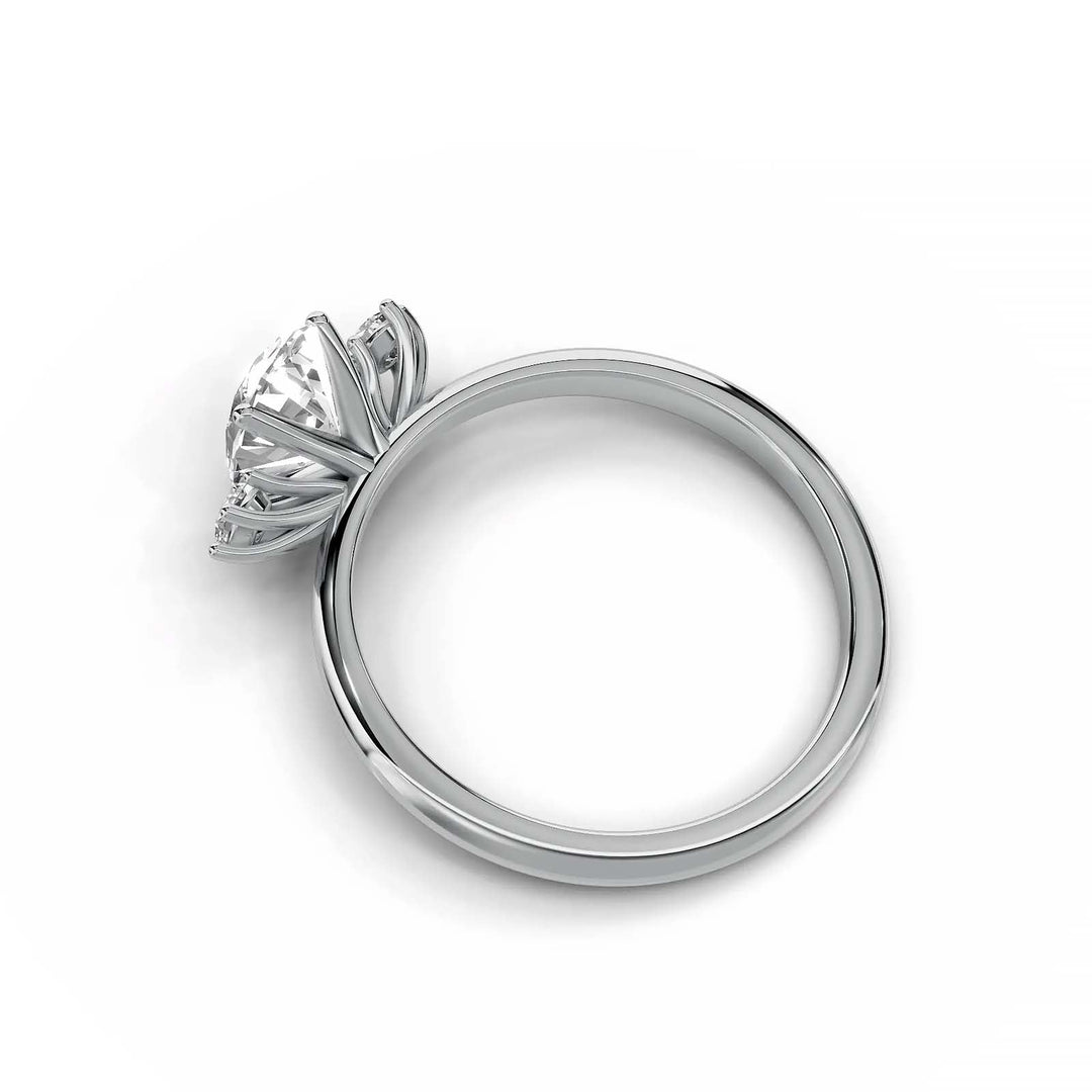 Oval diamond three-stone engagement ring, prong-set, low-profile, white gold.