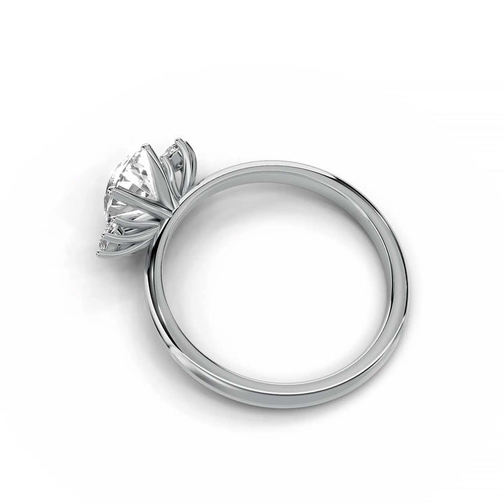 Oval diamond three-stone engagement ring, prong-set, low-profile, white gold.