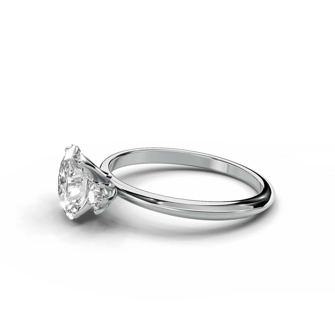 Oval diamond three-stone engagement ring, prong-set, low-profile, white gold.