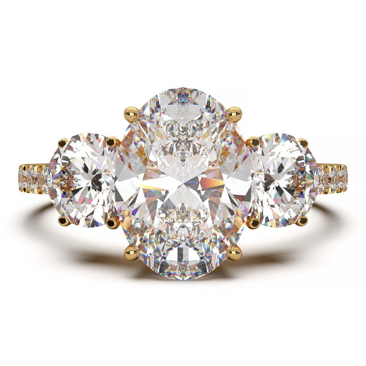 Three-stone engagement ring with 2-carat oval lab-grown diamond, round side stones, and pave band