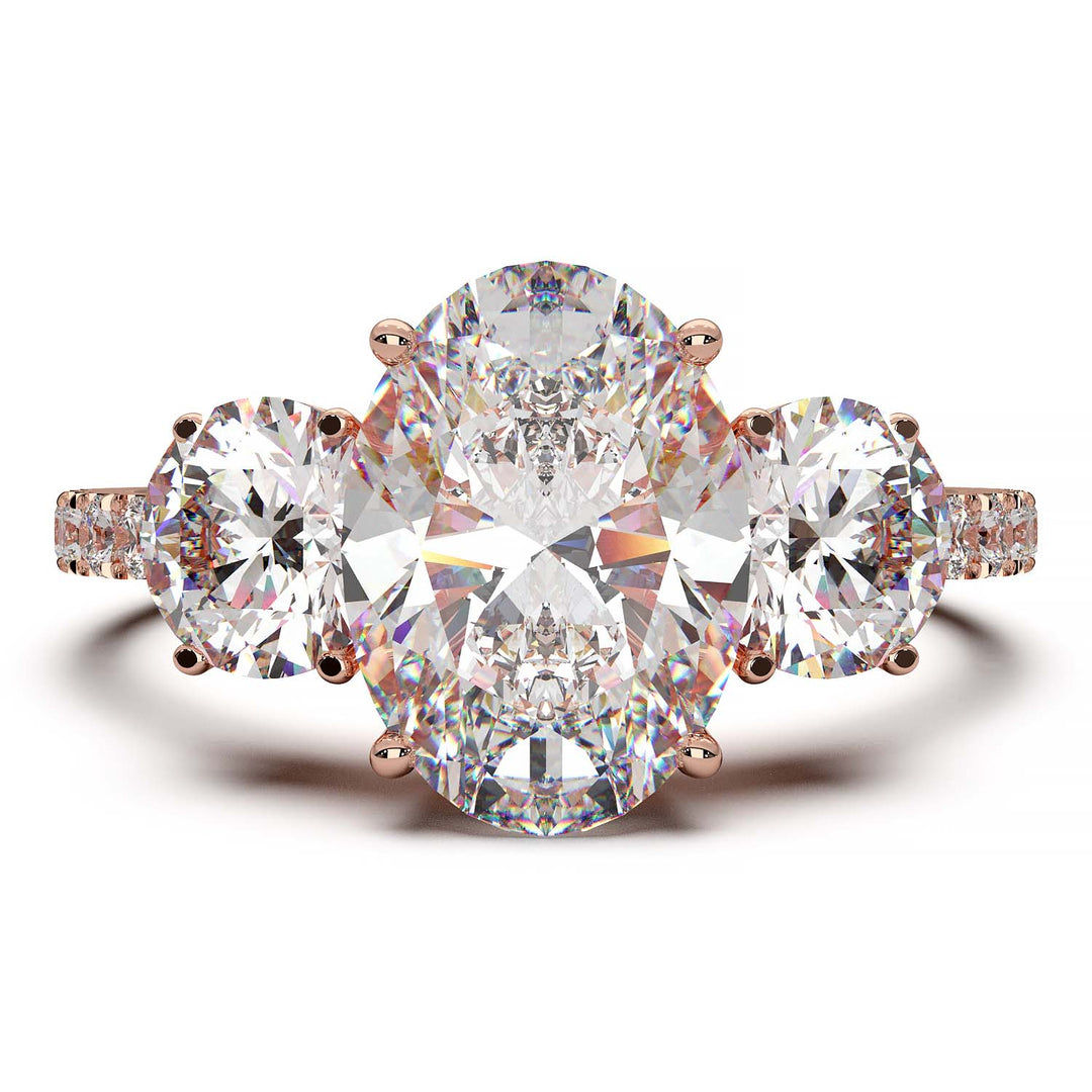 Three-stone engagement ring with 2-carat oval lab-grown diamond, round side stones, and pave band