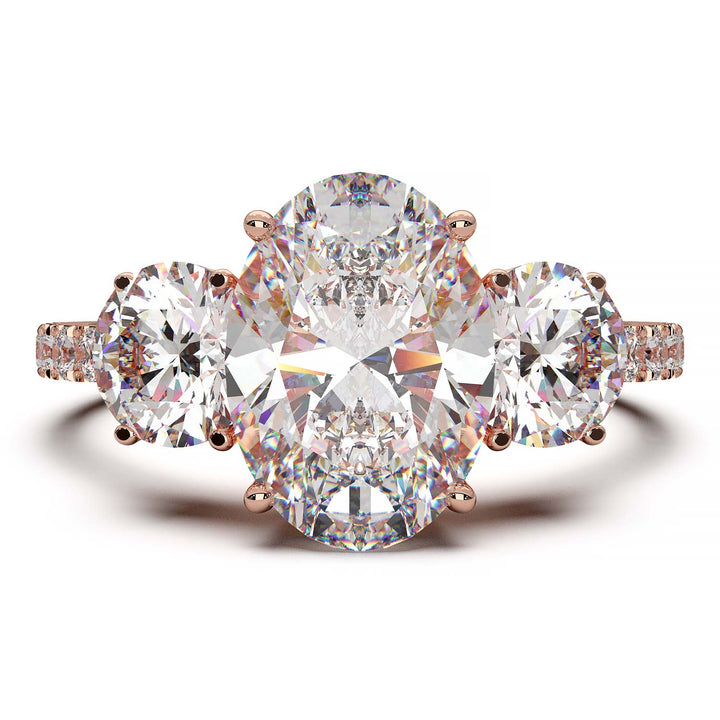 Three-stone engagement ring with 2-carat oval lab-grown diamond, round side stones, and pave band