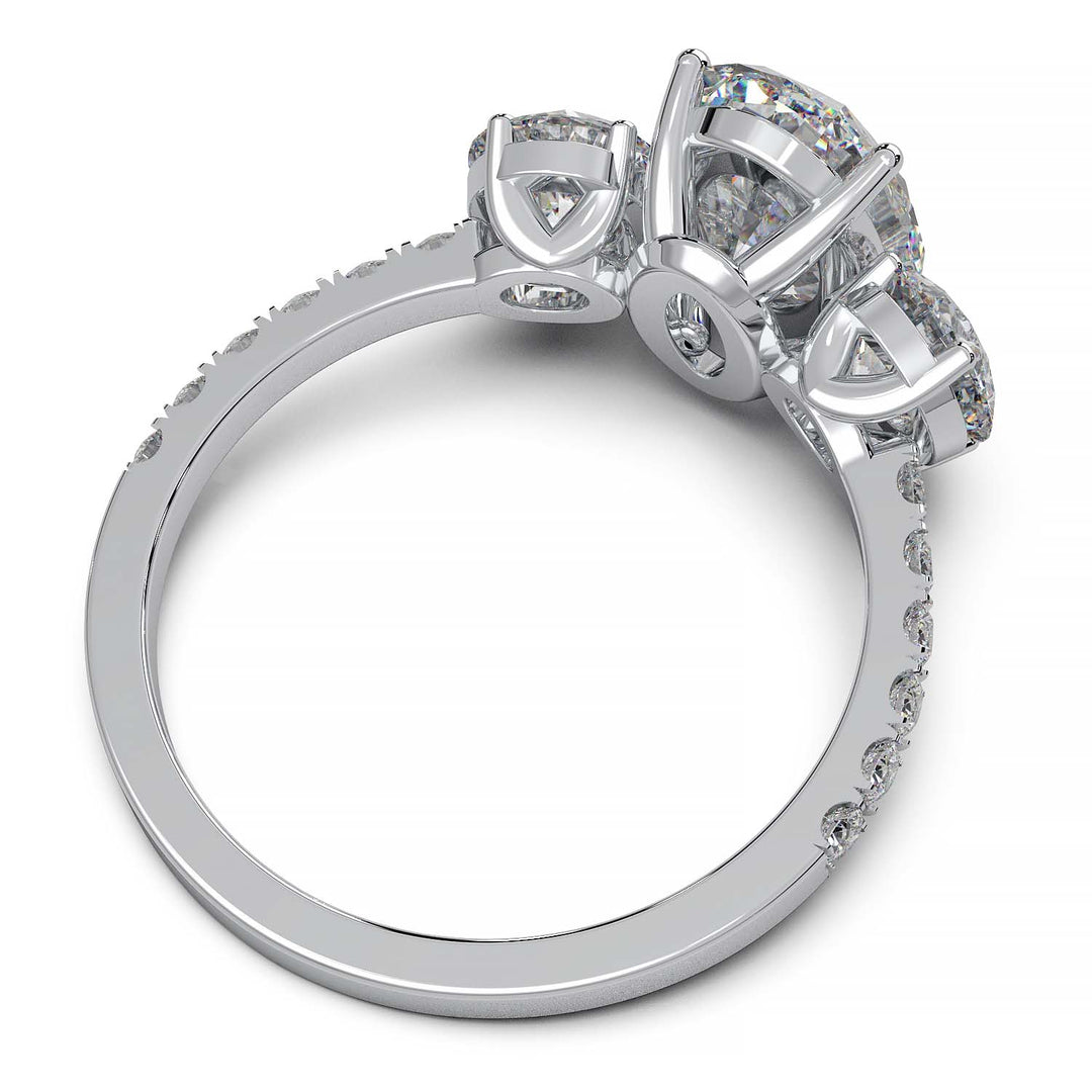 Three-stone engagement ring with 2-carat oval lab-grown diamond, round side stones, and pave band