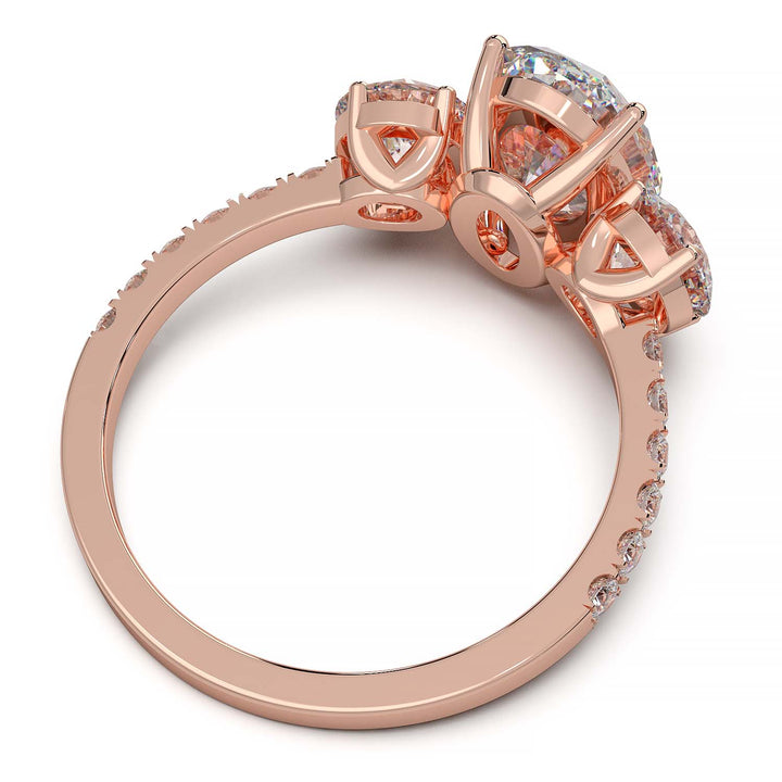 Three-stone engagement ring with 2-carat oval lab-grown diamond, round side stones, and pave band