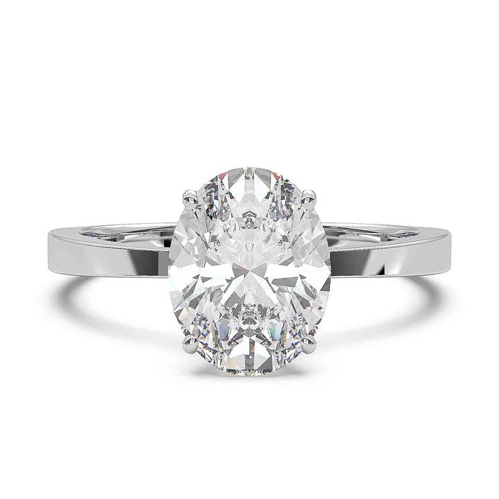 Oval diamond solitaire engagement ring with a tapered band, featuring a 1.6 CT lab-grown diamond, D color, VVS clarity.