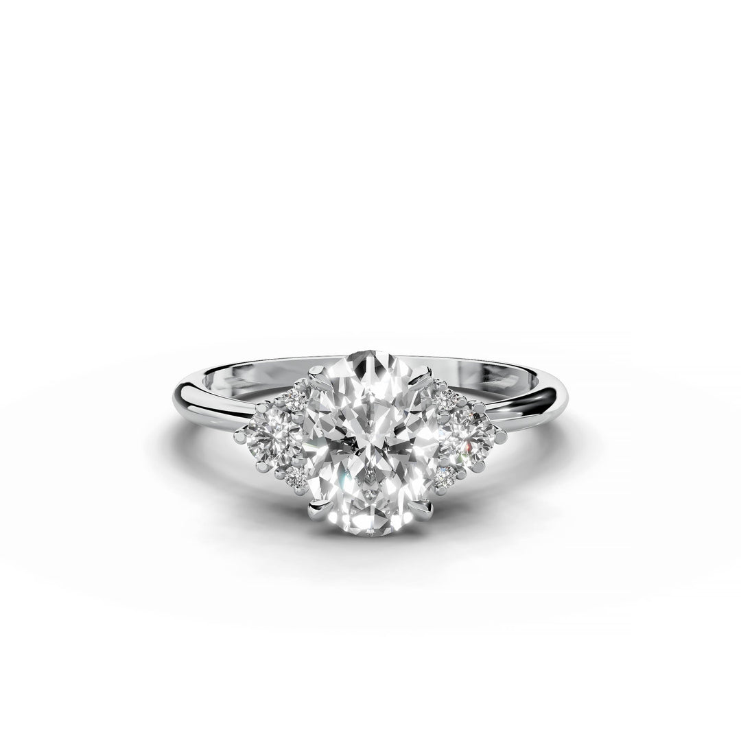 Oval diamond cluster engagement ring in white gold.