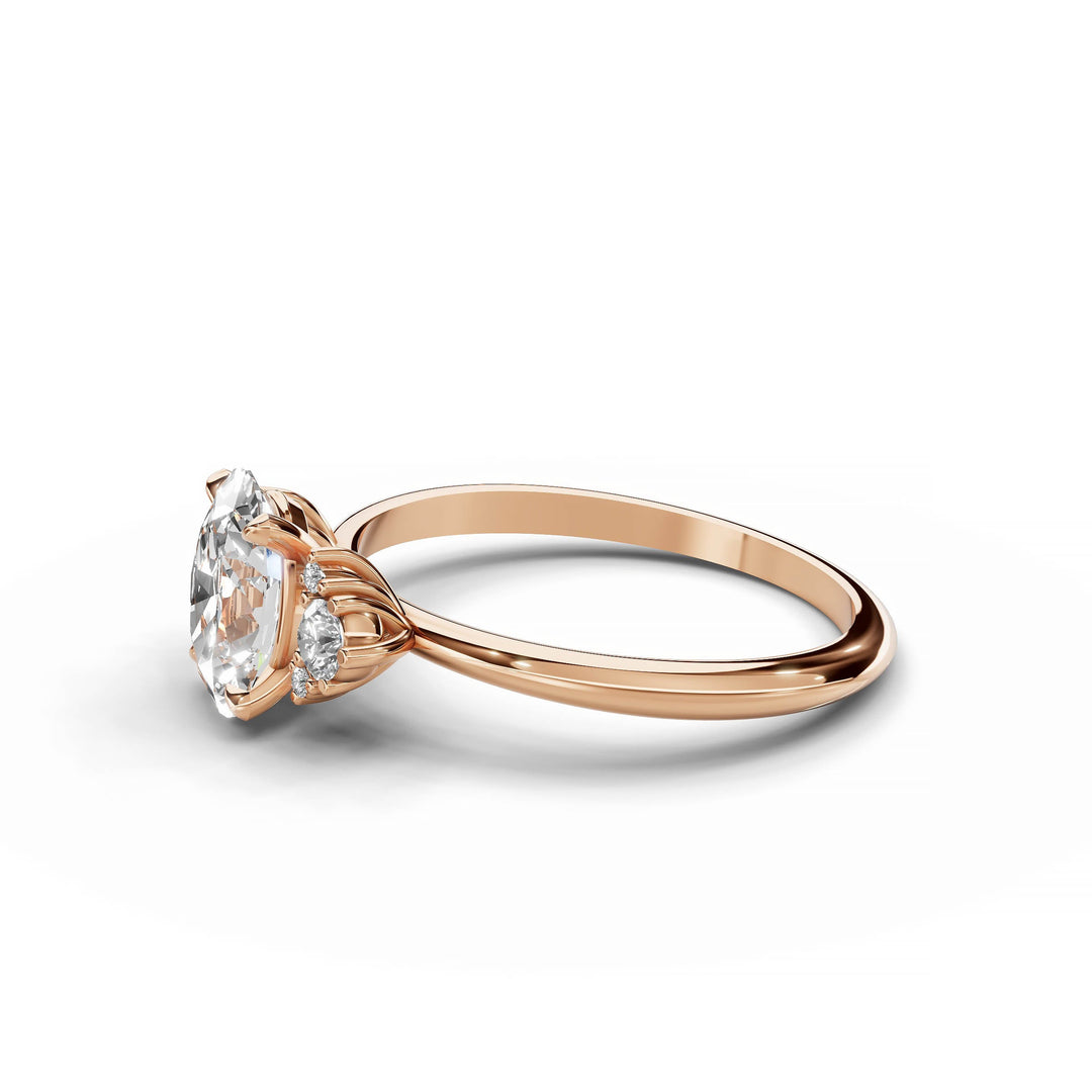 Oval diamond cluster engagement ring in rose gold.