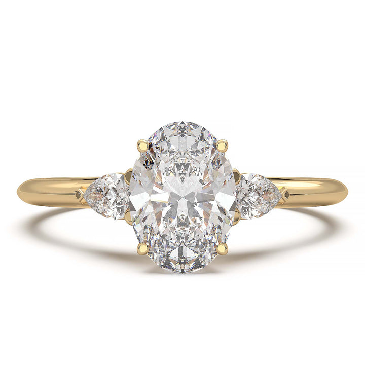 engagement ring featuring a 1 carat oval lab-grown diamond with pear-shaped side stones, held by unique cathedral-inspired prongs