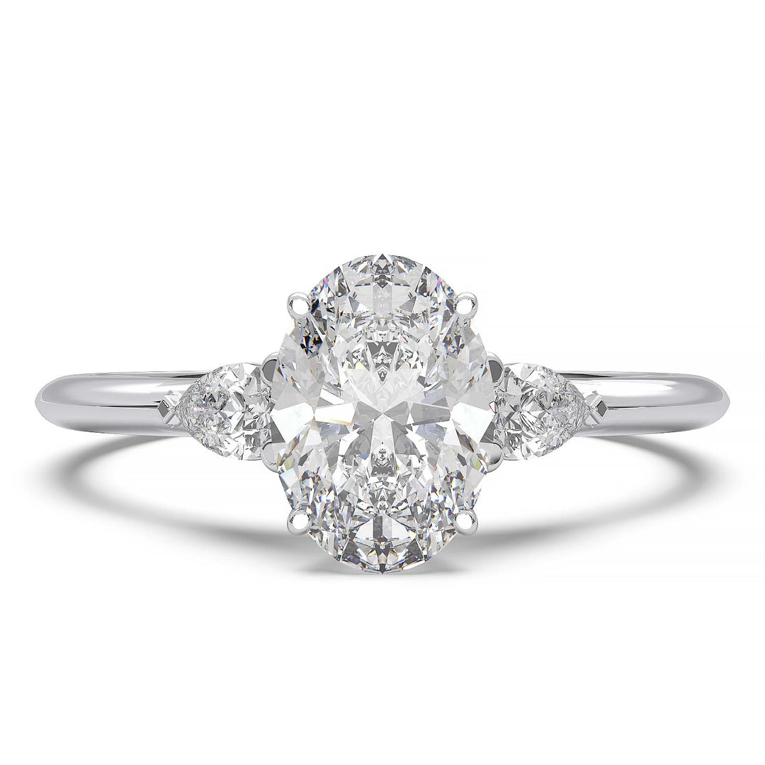 engagement ring featuring a 1 carat oval lab-grown diamond with pear-shaped side stones, held by unique cathedral-inspired prongs