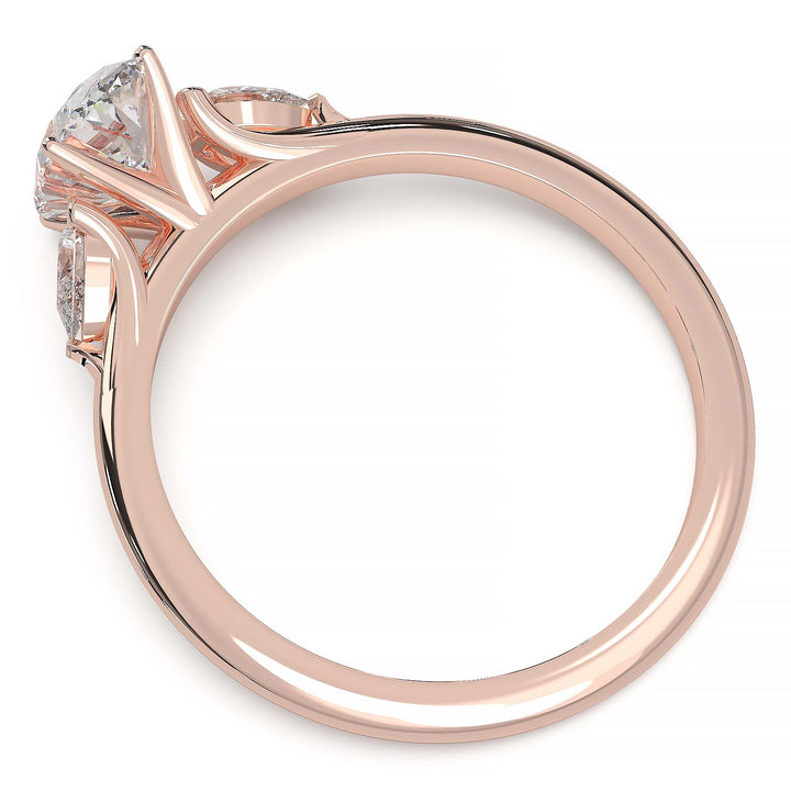 engagement ring featuring a 1 carat oval lab-grown diamond with pear-shaped side stones, held by unique cathedral-inspired prongs