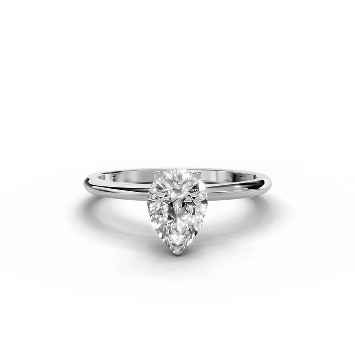 Pear-shaped diamond engagement ring in white gold with hidden halo design.