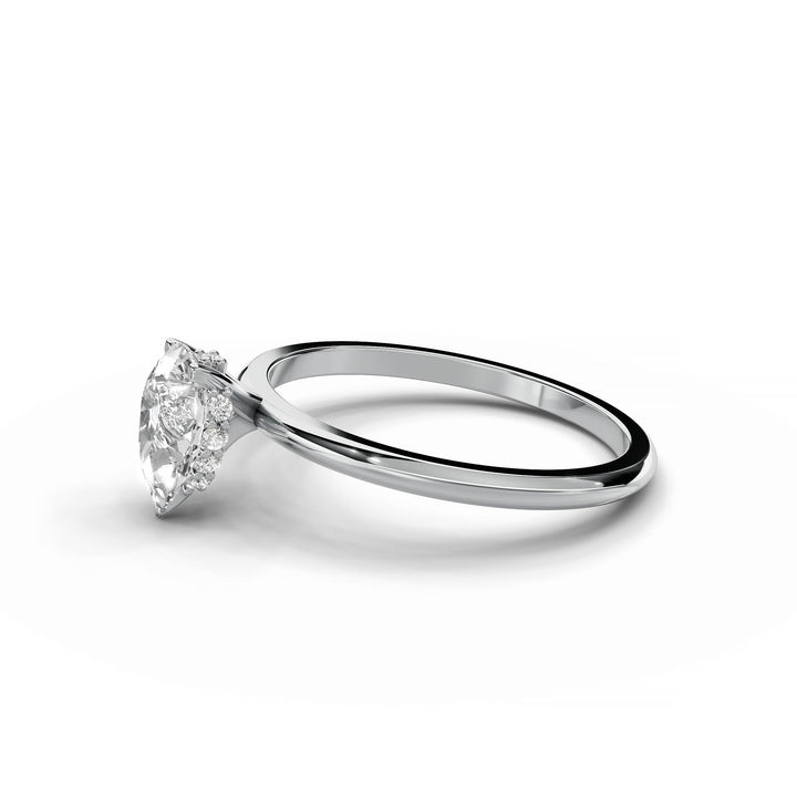 Pear-shaped diamond engagement ring in white gold with hidden halo design.