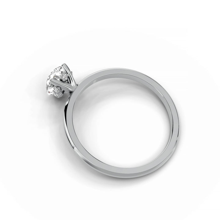 Pear-shaped diamond engagement ring in white gold with hidden halo design.