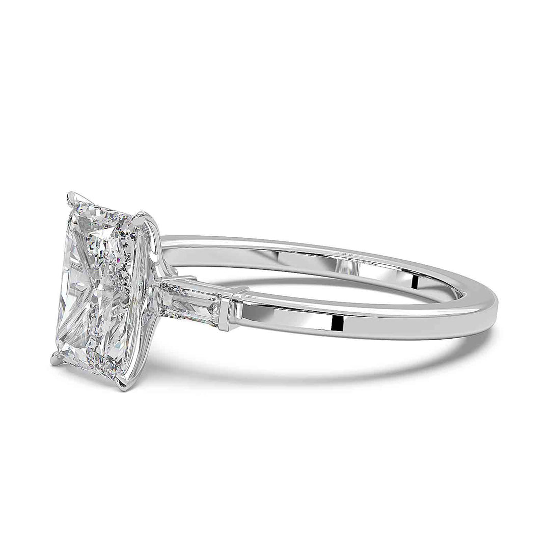 Radiant cut diamond three-stone engagement ring with 1.5 CT lab-grown center diamond and baguette side stones in a modern design.