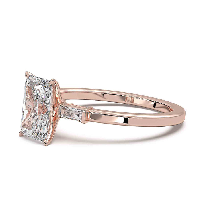 Radiant cut diamond three-stone engagement ring with 1.5 CT lab-grown center diamond and baguette side stones in a modern design.