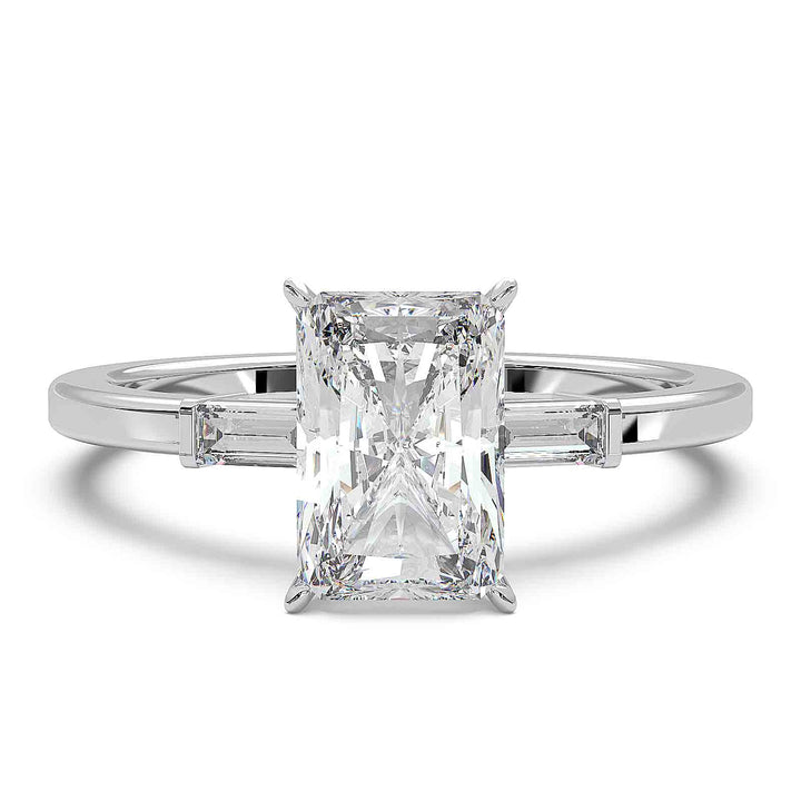 Radiant cut diamond three-stone engagement ring with 1.5 CT lab-grown center diamond and baguette side stones in a modern design.