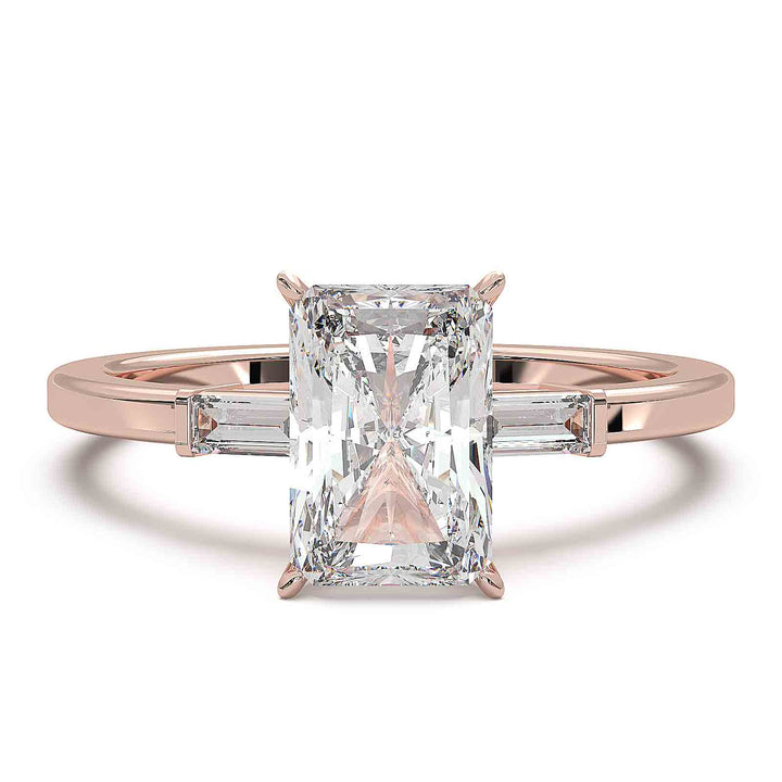 Radiant cut diamond three-stone engagement ring with 1.5 CT lab-grown center diamond and baguette side stones in a modern design.