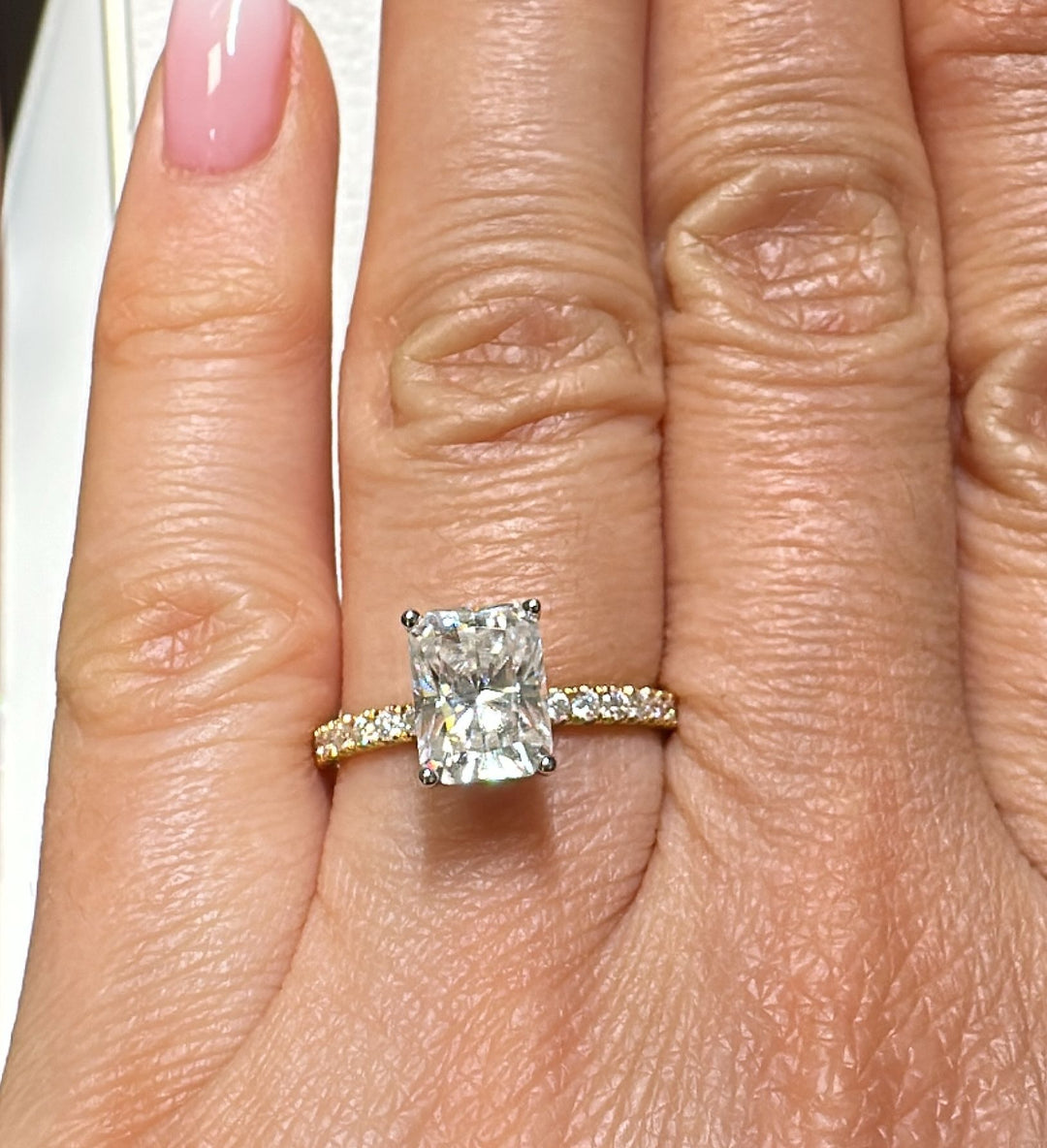 8x6mm radiant moissanite engagement ring with moissanite band in 14K gold.