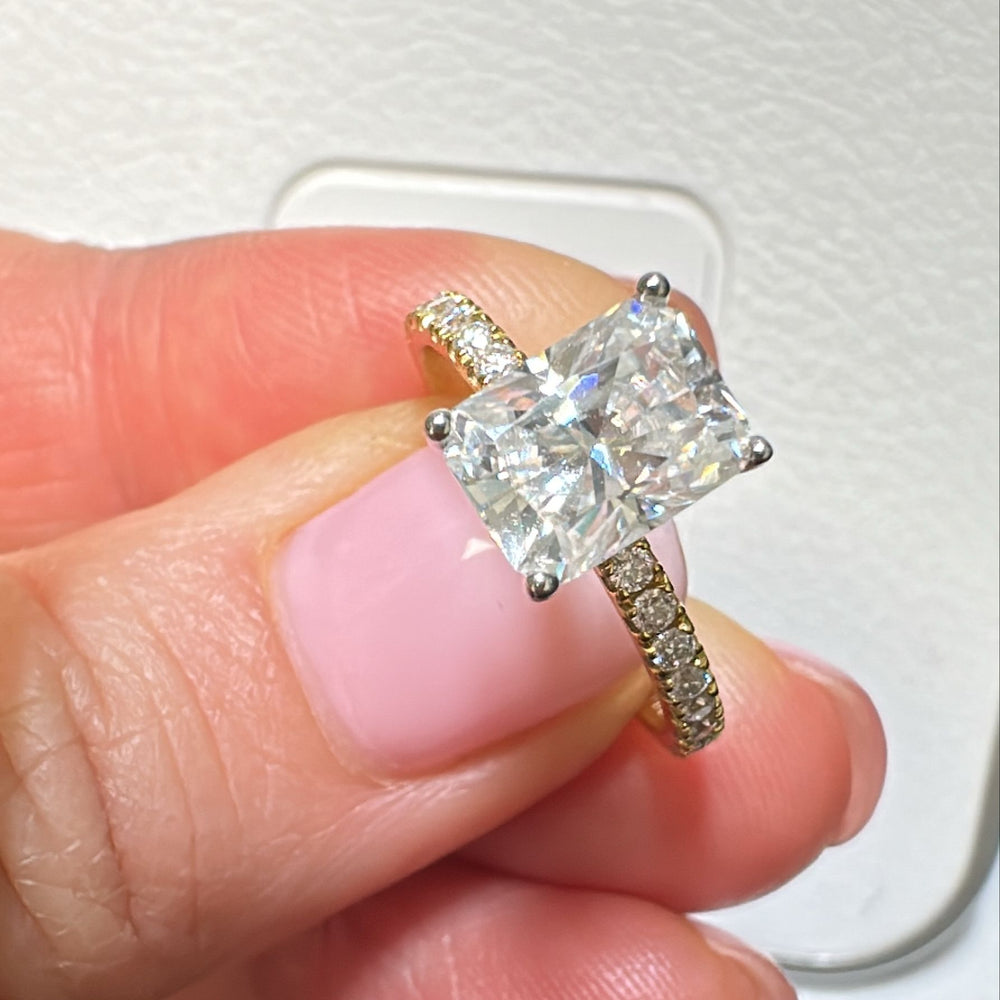 8x6mm radiant moissanite engagement ring with moissanite band in 14K gold.