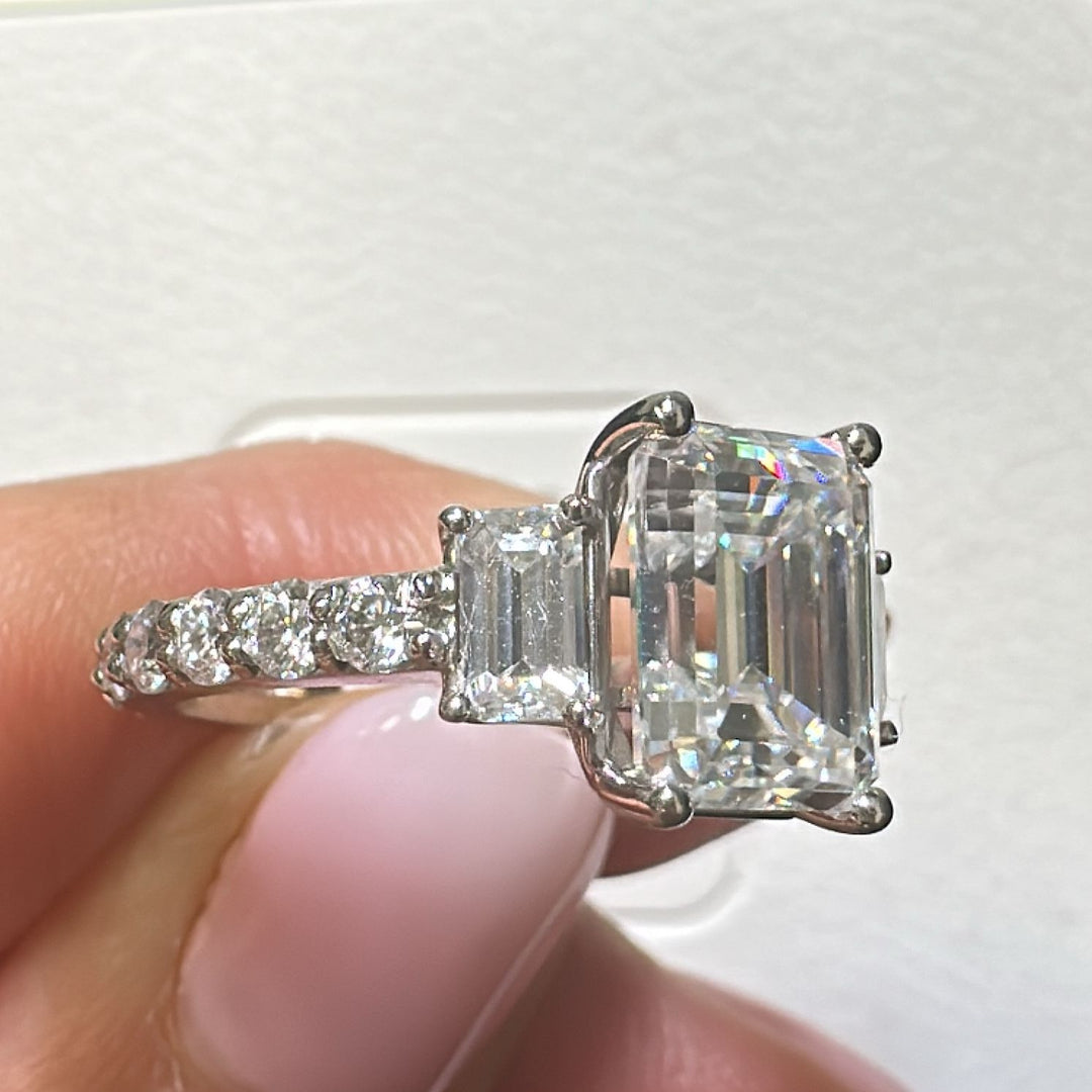 3.7 Ct emerald moissanite three-stone engagement ring in 14K gold.