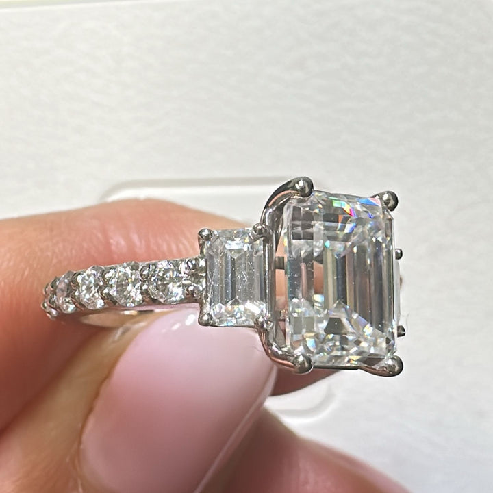 3.7 Ct emerald moissanite three-stone engagement ring in 14K gold.