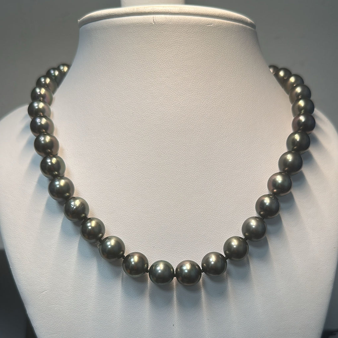 AAA-quality Tahitian black pearl necklace with 37 round pearls, 14K white gold clasp, and small diamonds.