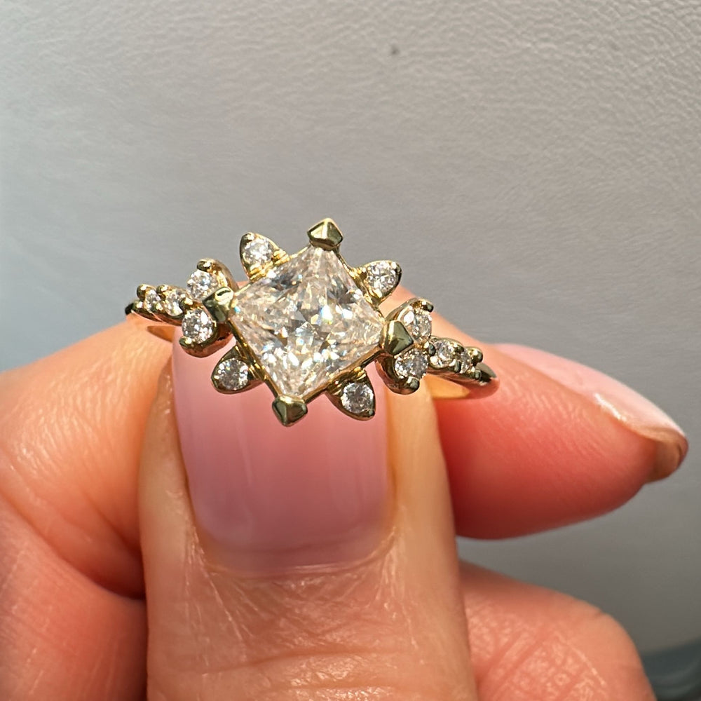 Moissanite engagement ring with 0.90CT center stone, accent stones, set in 14K gold.