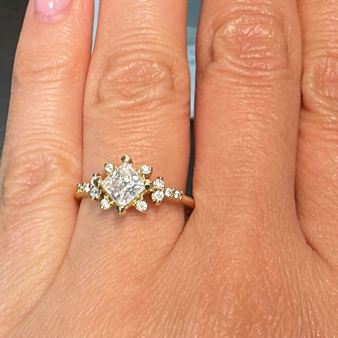 Moissanite engagement ring with 0.90CT center stone, accent stones, set in 14K gold.