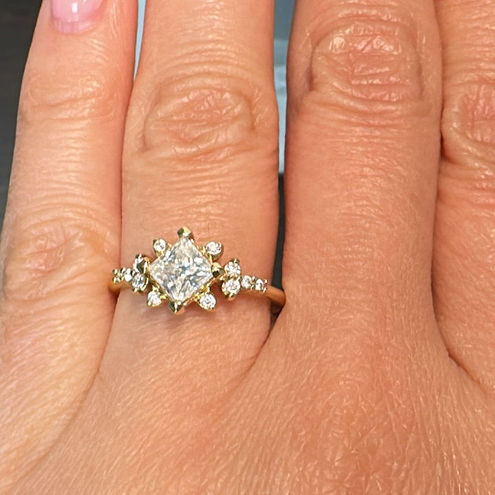 Moissanite engagement ring with 0.90CT center stone, accent stones, set in 14K gold.
