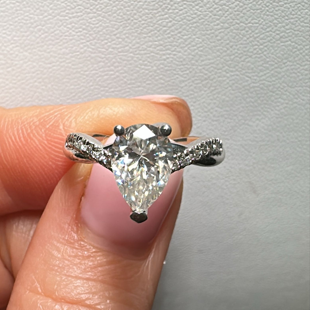 Moissanite pear-shaped engagement ring with 1.20CT center stone, accent moissanite, set in 14K gold.