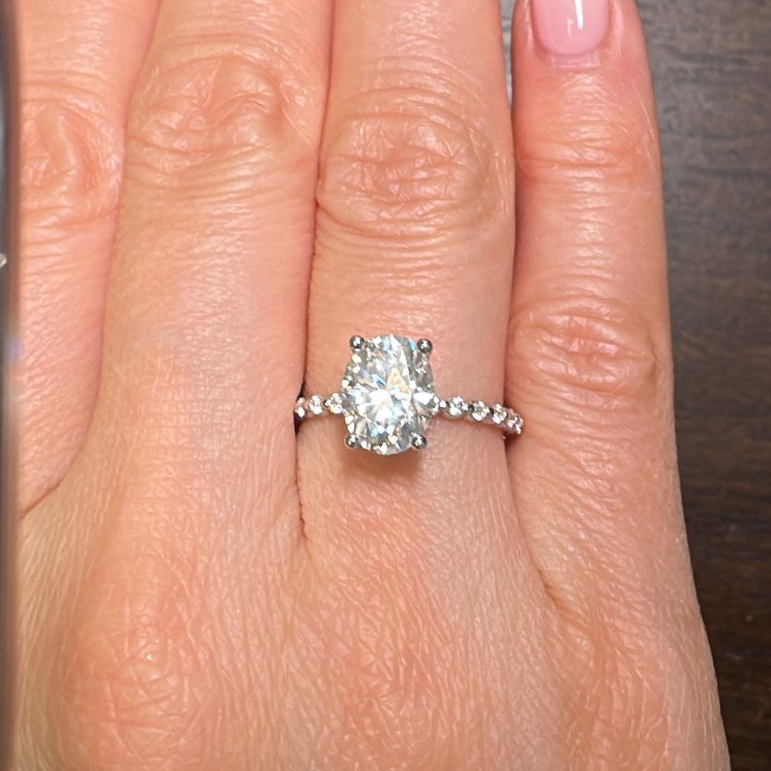 2CT oval moissanite engagement ring, 9x7mm colorless moissanite, with a pave band in 14K gold.