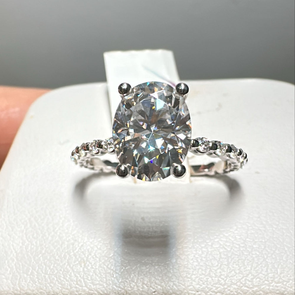 2CT oval moissanite engagement ring, 9x7mm colorless moissanite, with a pave band in 14K gold.