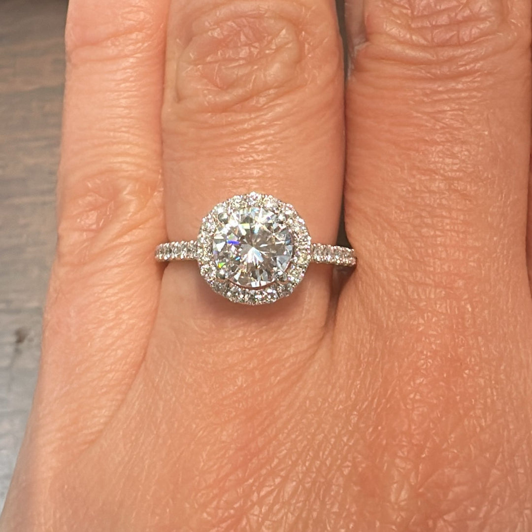 1 CT round moissanite engagement ring with hidden halo and diamonds in 14K gold.