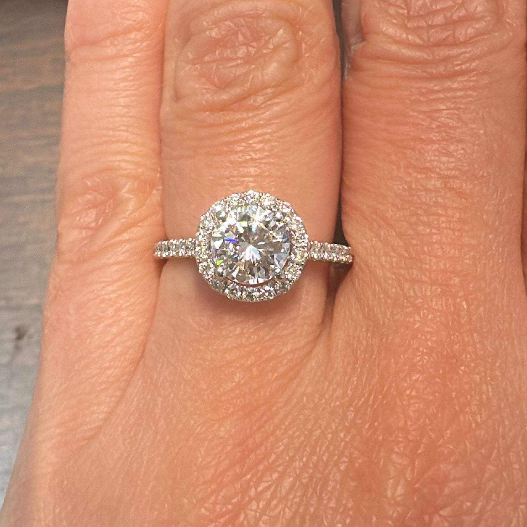 1 CT round moissanite engagement ring with hidden halo and diamonds in 14K gold.