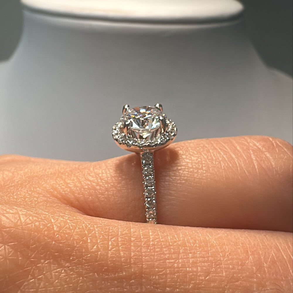 1 CT round moissanite engagement ring with hidden halo and diamonds in 14K gold.
