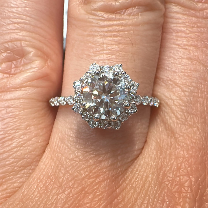 1 CT round moissanite halo engagement ring with moissanite accents in 14K white gold.