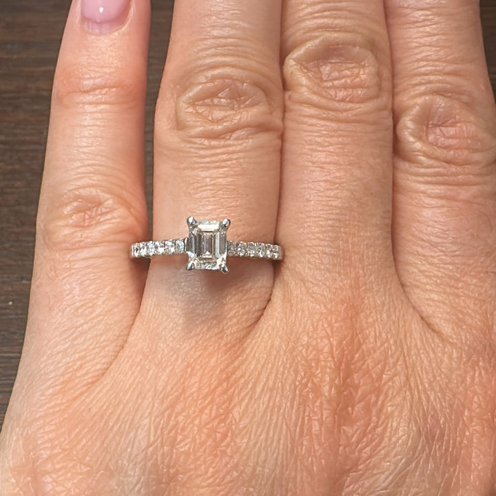 0.66 CT emerald cut lab-grown diamond ring with accent diamonds in 14K white gold.