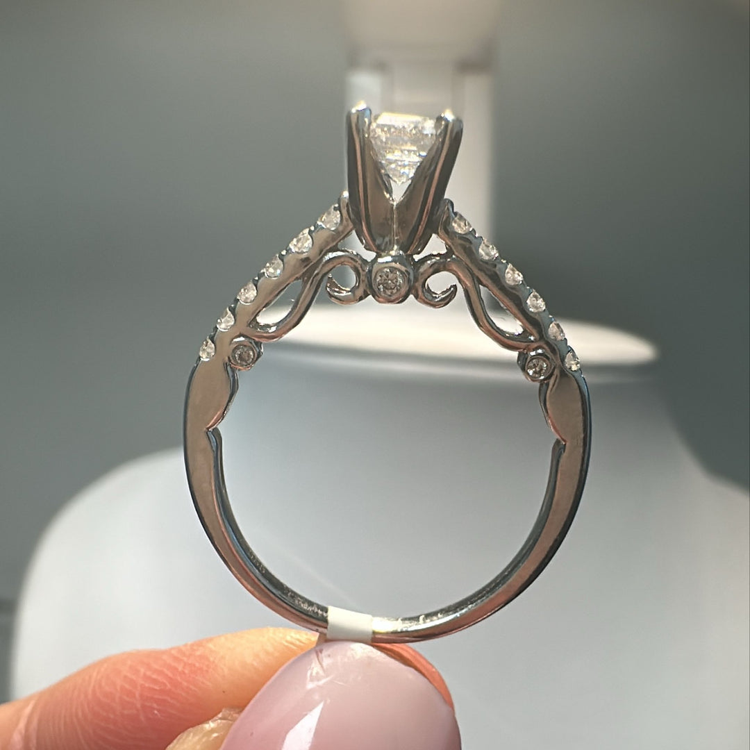 0.66 CT emerald cut lab-grown diamond ring with accent diamonds in 14K white gold.