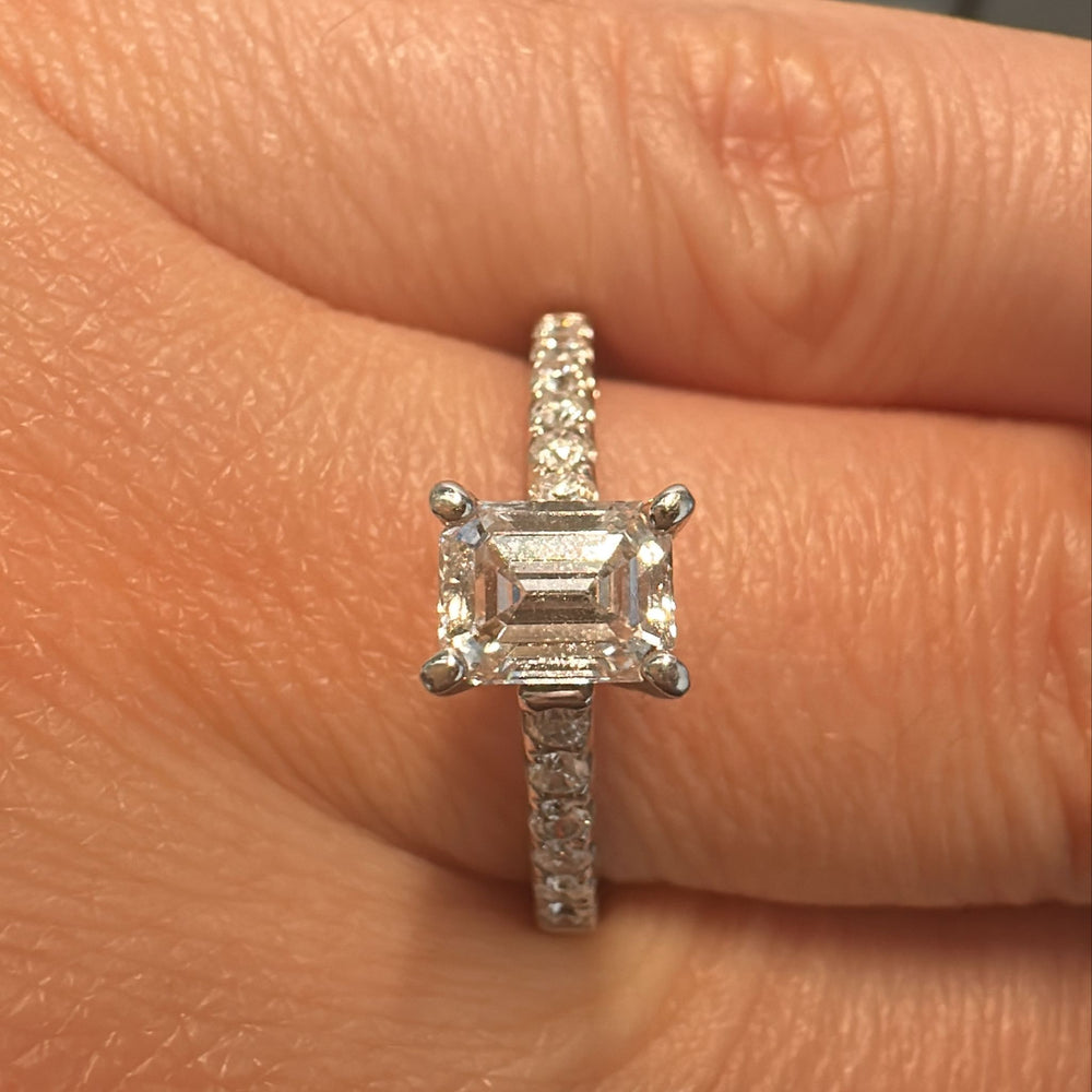 0.66 CT emerald cut lab-grown diamond ring with accent diamonds in 14K white gold.