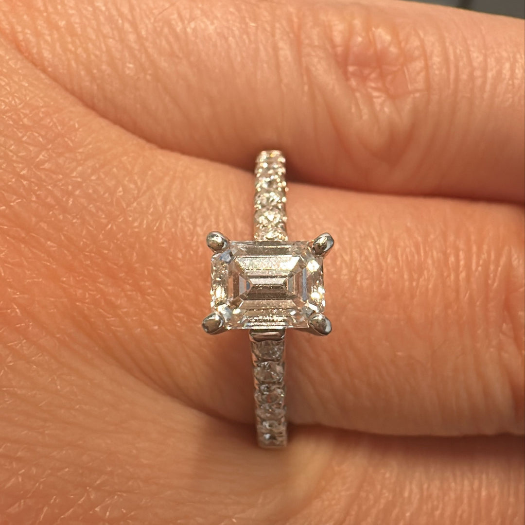 0.66 CT emerald cut lab-grown diamond ring with accent diamonds in 14K white gold.